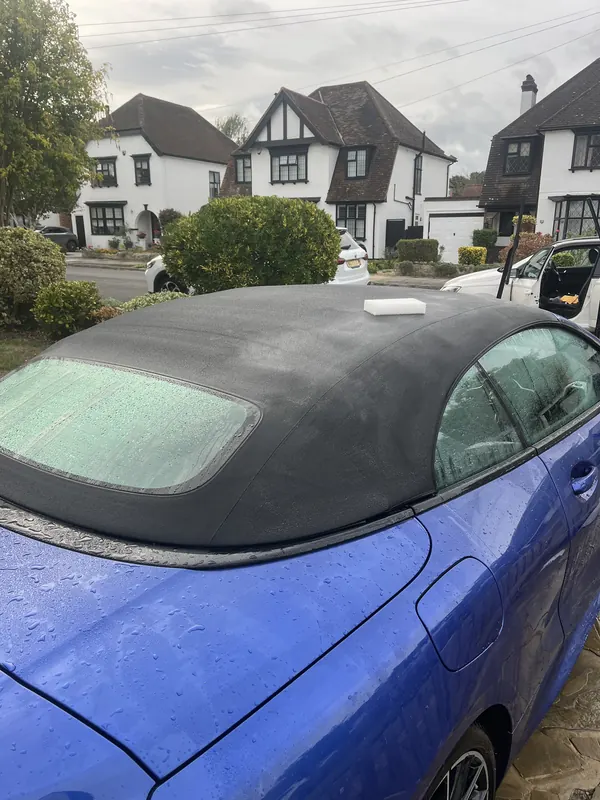Scrubber on a convertible soft top during cleaning